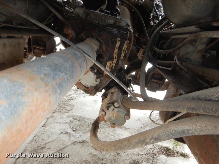 image for item DE1758 1984 Ford F700 flatbed truck with pot hole patcher