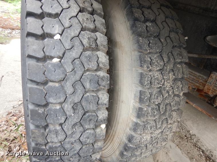 image for item DE1758 1984 Ford F700 flatbed truck with pot hole patcher