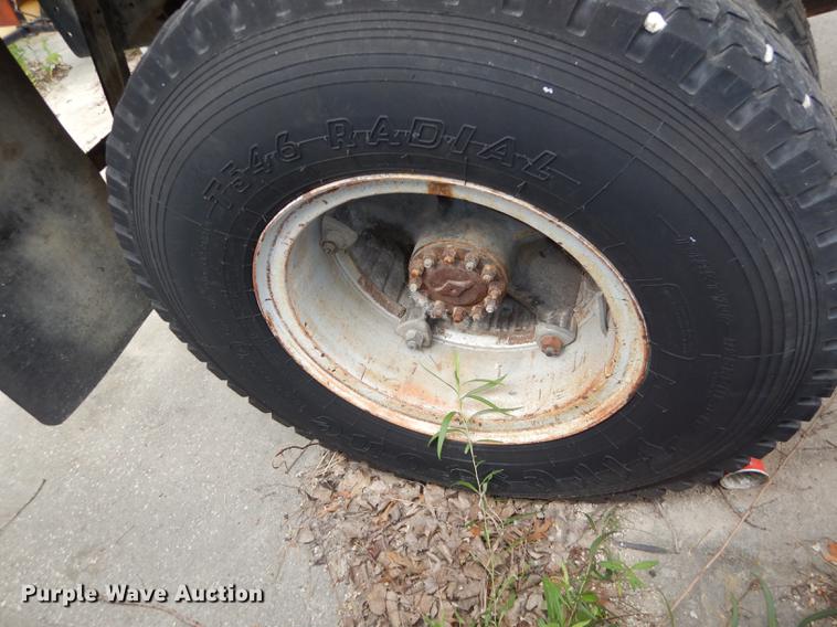 image for item DE1758 1984 Ford F700 flatbed truck with pot hole patcher