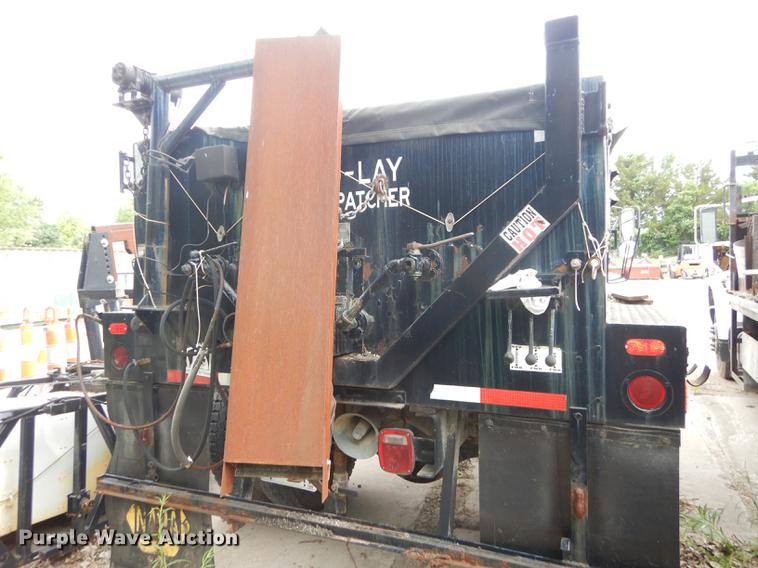 image for item DE1758 1984 Ford F700 flatbed truck with pot hole patcher