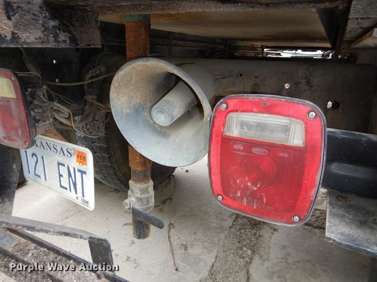 image for item DE1758 1984 Ford F700 flatbed truck with pot hole patcher