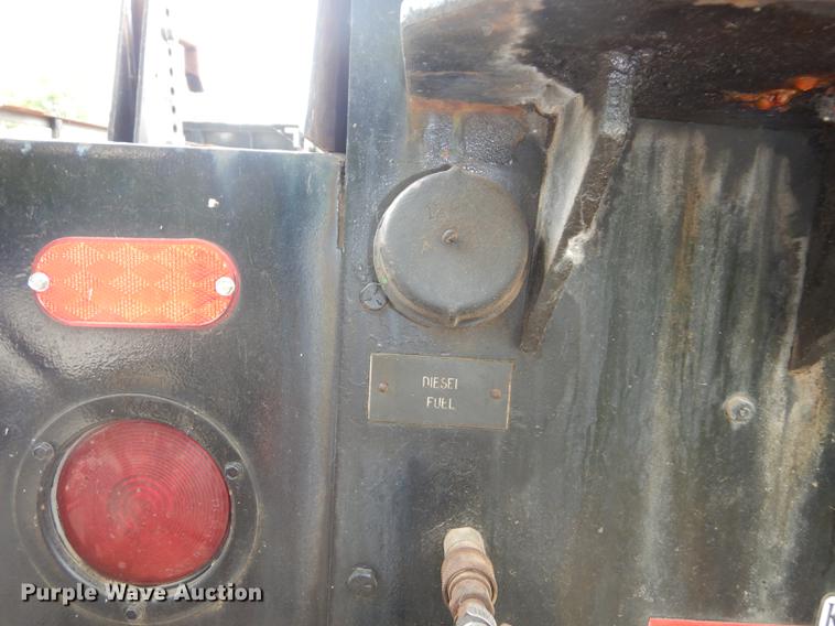 image for item DE1758 1984 Ford F700 flatbed truck with pot hole patcher