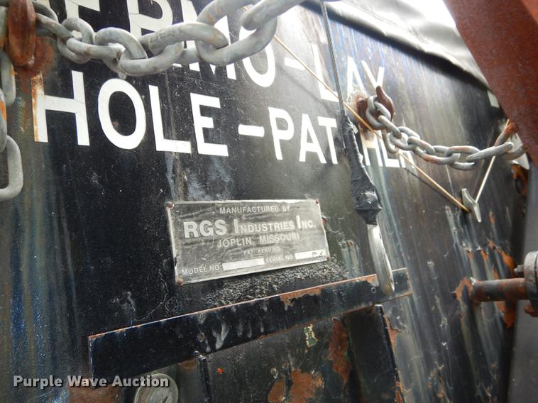 image for item DE1758 1984 Ford F700 flatbed truck with pot hole patcher