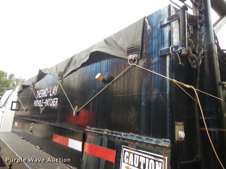 image for item DE1758 1984 Ford F700 flatbed truck with pot hole patcher