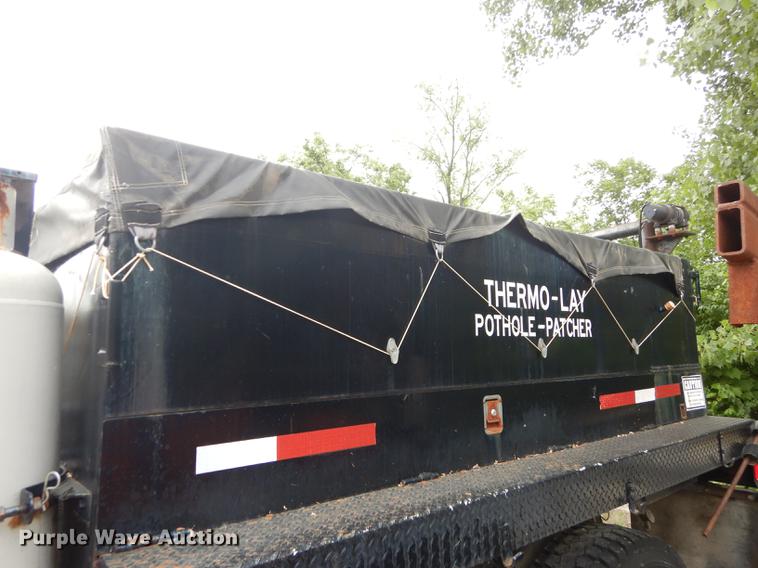 image for item DE1758 1984 Ford F700 flatbed truck with pot hole patcher