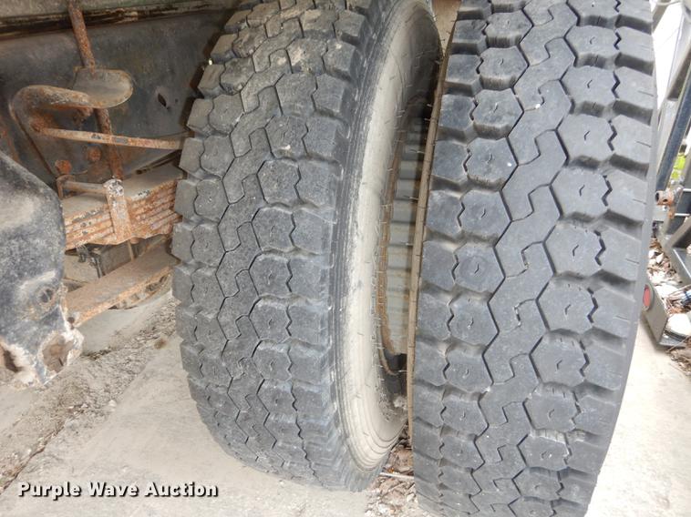 image for item DE1758 1984 Ford F700 flatbed truck with pot hole patcher