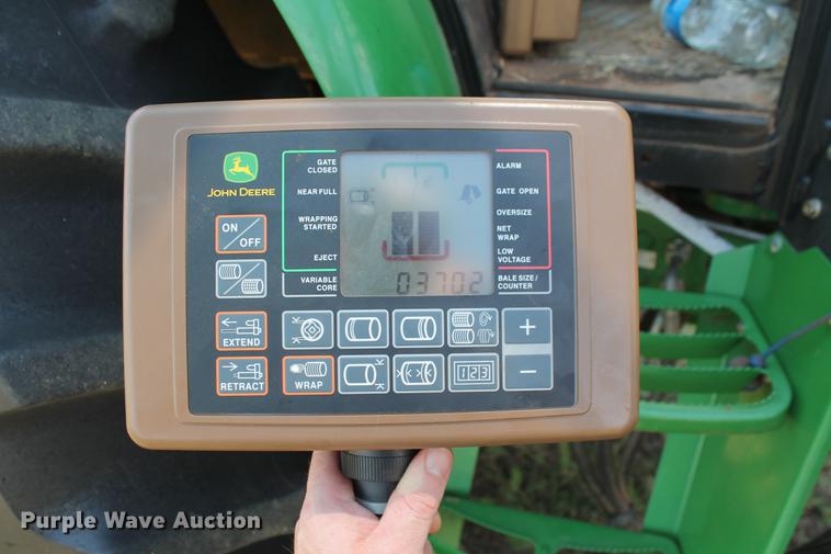 image for item DD5237 2015 John Deere 569 Mega Wide Plus round baler