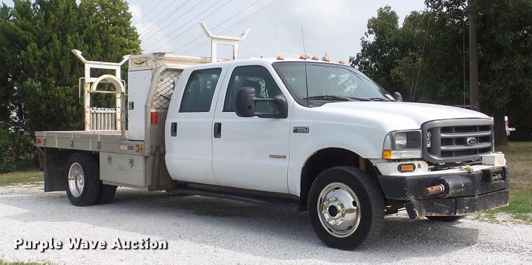 image for item DD7353 2003 Ford F550 Super Duty XL Crew Cab flatbed truck