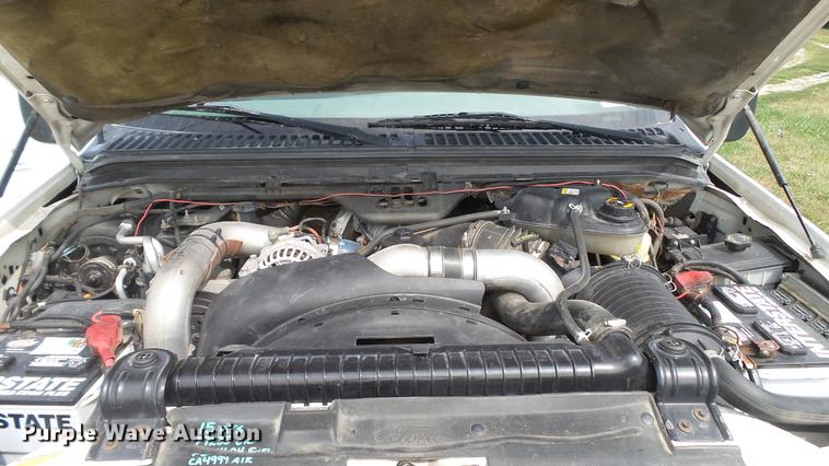 image for item DD7353 2003 Ford F550 Super Duty XL Crew Cab flatbed truck