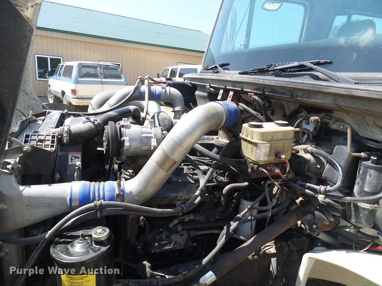 image for item DE5185 2000 Freightliner FL60 Crew Cab flatbed truck