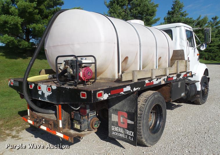 image for item L5702 1990 International 7100 flatbed truck with water tank