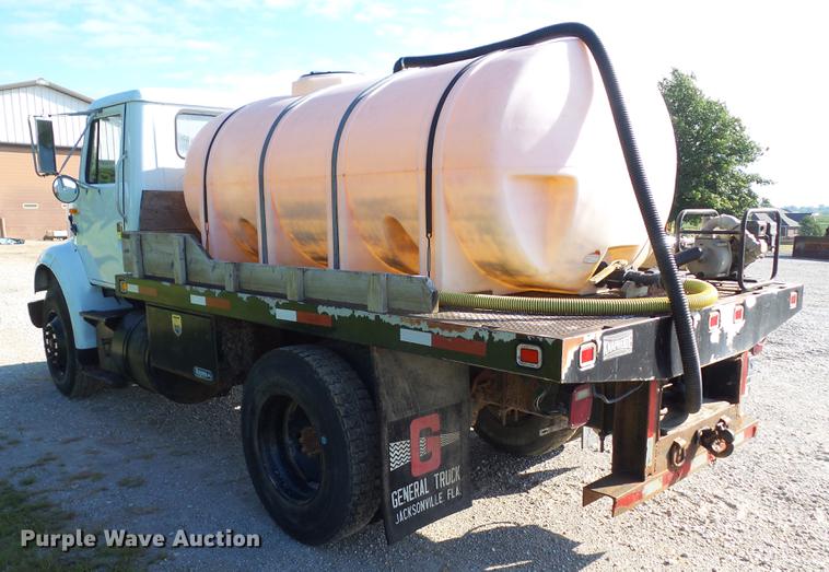 image for item L5702 1990 International 7100 flatbed truck with water tank