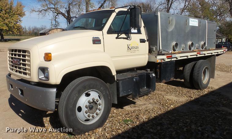 image for item DE7318 1997 GMC C7500 flatbed truck with fish transporter