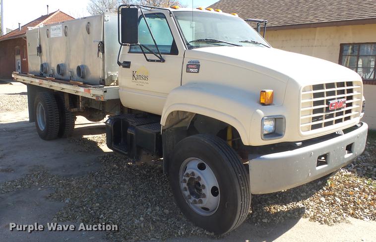 image for item DE7318 1997 GMC C7500 flatbed truck with fish transporter