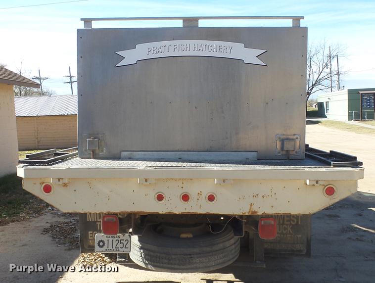 image for item DE7318 1997 GMC C7500 flatbed truck with fish transporter