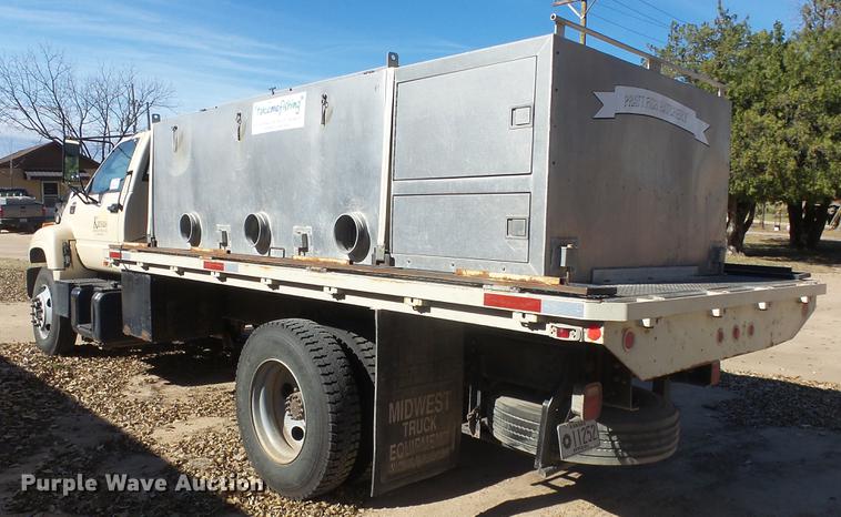 image for item DE7318 1997 GMC C7500 flatbed truck with fish transporter