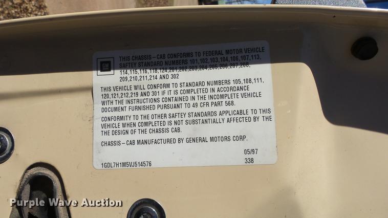 image for item DE7318 1997 GMC C7500 flatbed truck with fish transporter