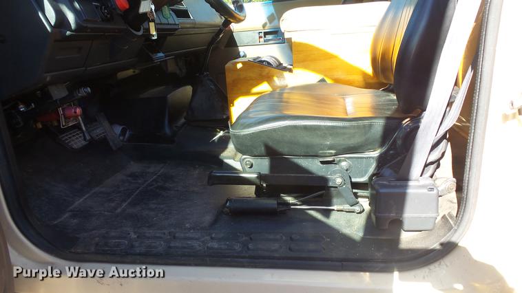 image for item DE7318 1997 GMC C7500 flatbed truck with fish transporter