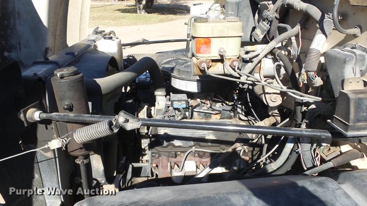 image for item DE7318 1997 GMC C7500 flatbed truck with fish transporter