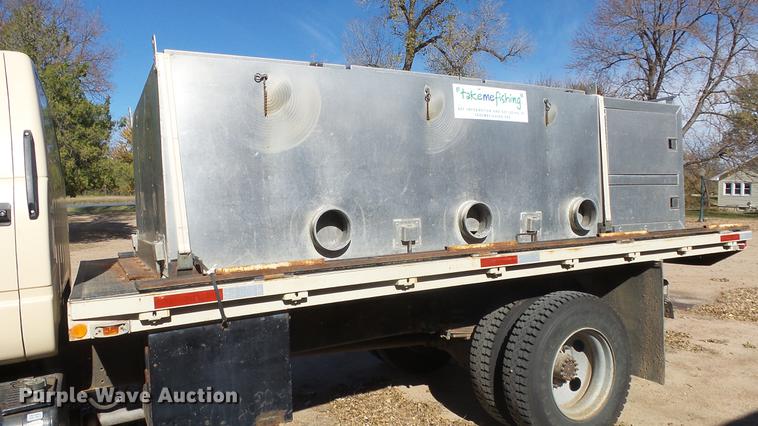 image for item DE7318 1997 GMC C7500 flatbed truck with fish transporter