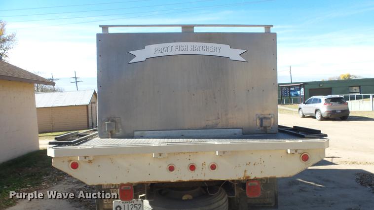 image for item DE7318 1997 GMC C7500 flatbed truck with fish transporter