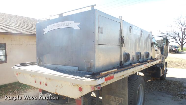 image for item DE7318 1997 GMC C7500 flatbed truck with fish transporter