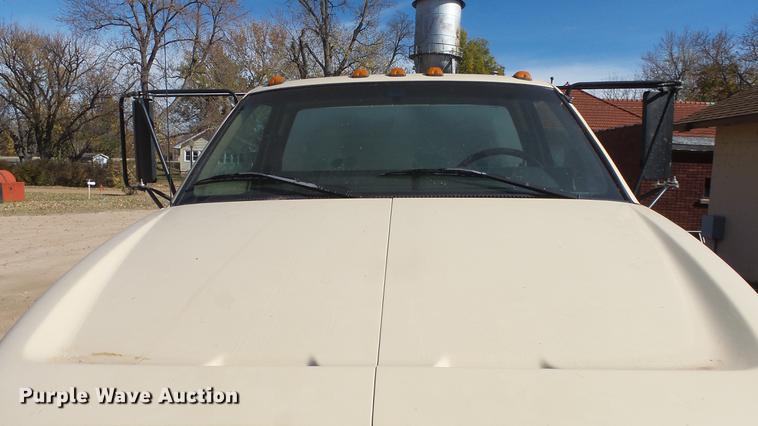 image for item DE7318 1997 GMC C7500 flatbed truck with fish transporter