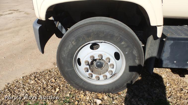 image for item DE7318 1997 GMC C7500 flatbed truck with fish transporter