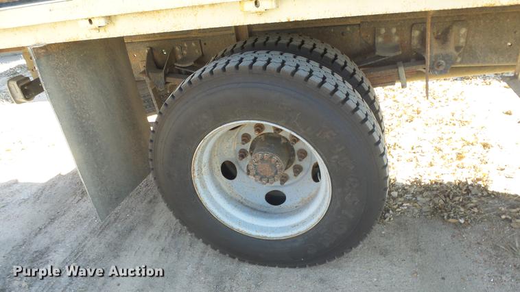 image for item DE7318 1997 GMC C7500 flatbed truck with fish transporter