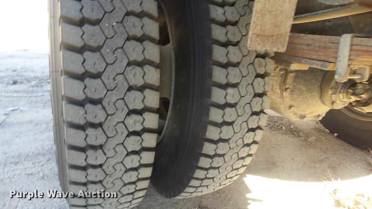 image for item DE7318 1997 GMC C7500 flatbed truck with fish transporter