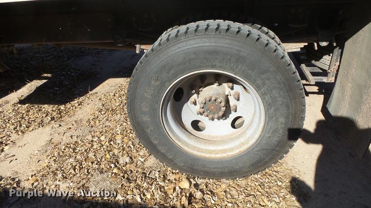 image for item DE7318 1997 GMC C7500 flatbed truck with fish transporter