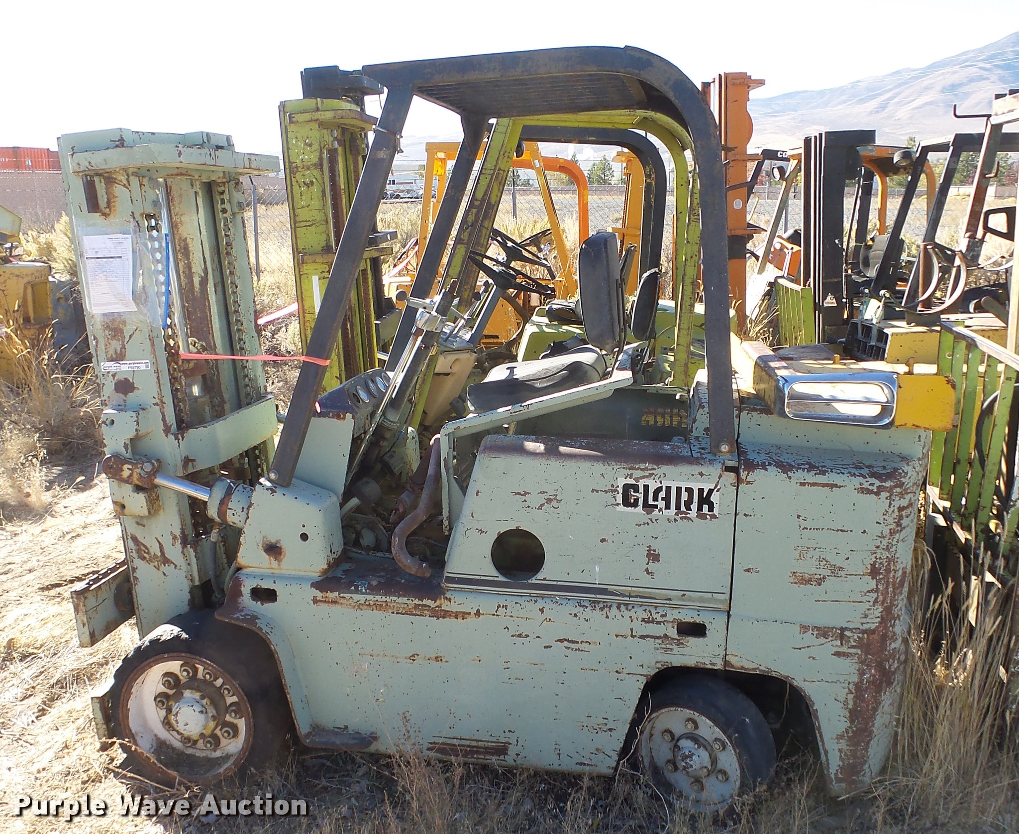 (5) Clark salvage forklifts in Reno, NV Item FS9790 sold Purple Wave