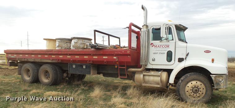 image for item EI9723 2002 Peterbilt 330 flatbed water truck