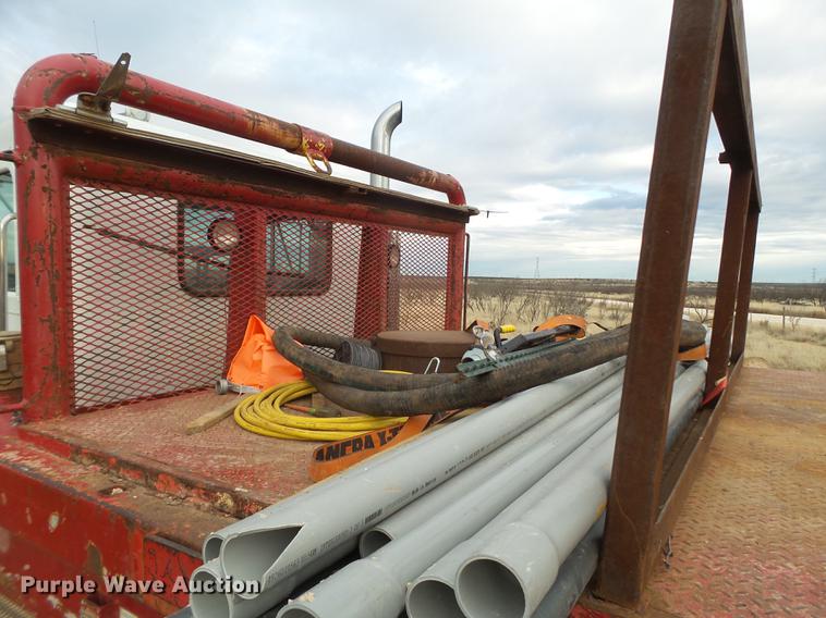 image for item EI9723 2002 Peterbilt 330 flatbed water truck