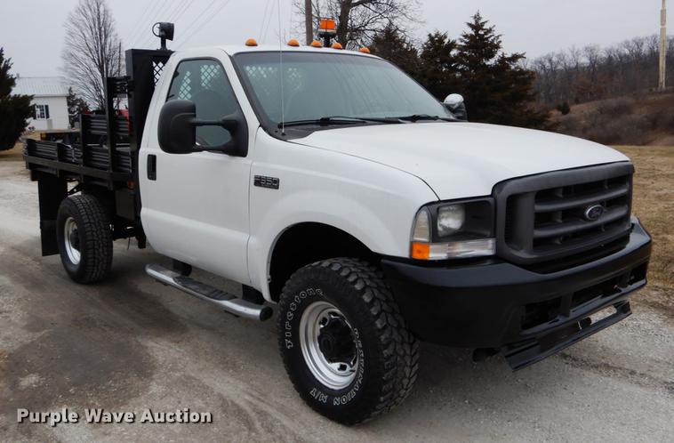 image for item DE6031 2004 Ford F350 Super Duty XL flatbed pickup truck