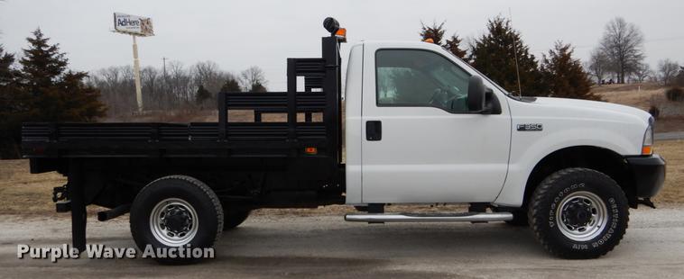image for item DE6031 2004 Ford F350 Super Duty XL flatbed pickup truck