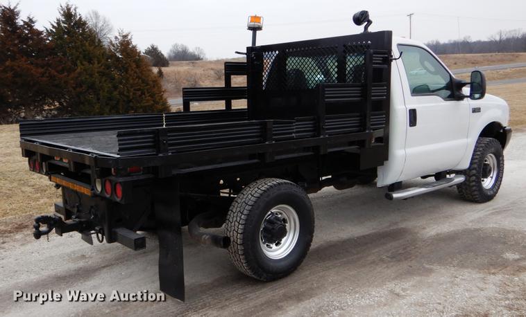 image for item DE6031 2004 Ford F350 Super Duty XL flatbed pickup truck