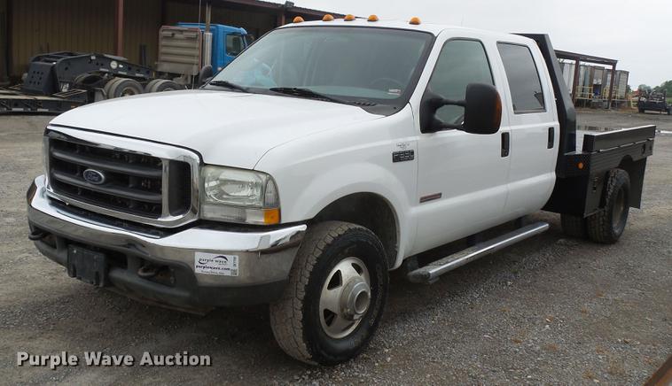 image for item DE7792 2004 Ford F350 Super Duty Crew Cab flatbed pickup truck