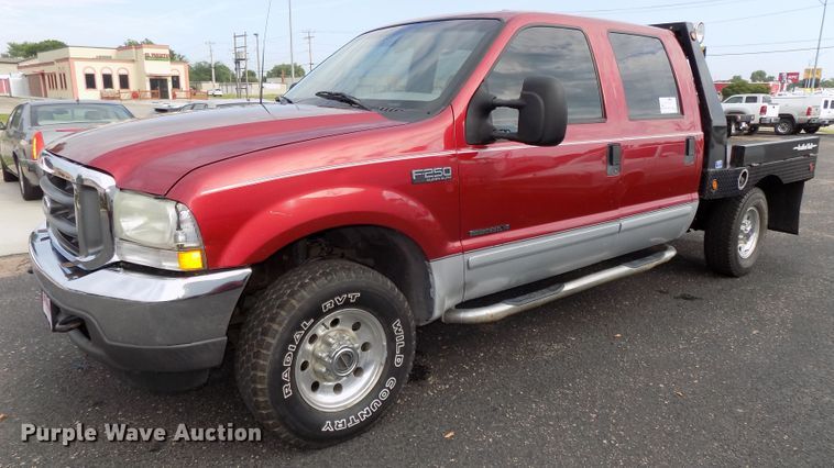 image for item DE7729 2002 Ford F250 Super Duty XLT Crew Cab flatbed pickup truck