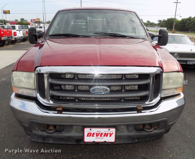 image for item DE7729 2002 Ford F250 Super Duty XLT Crew Cab flatbed pickup truck