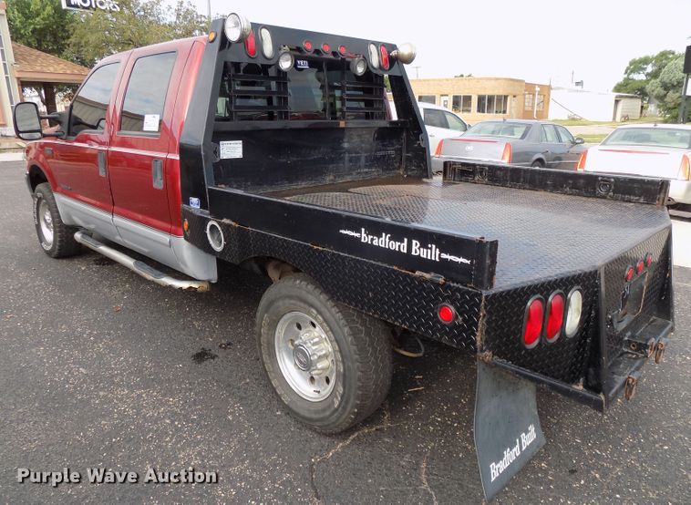 image for item DE7729 2002 Ford F250 Super Duty XLT Crew Cab flatbed pickup truck