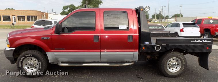 image for item DE7729 2002 Ford F250 Super Duty XLT Crew Cab flatbed pickup truck
