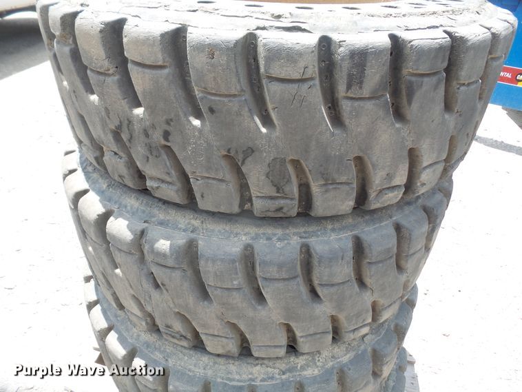 image for item FJ9152 (4) 12-16.5 solid skid steer tires and wheels