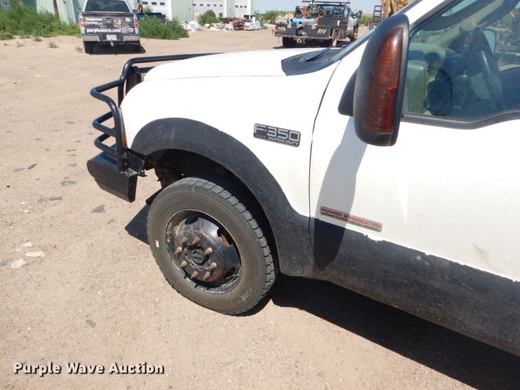 image for item FY9691 2004 Ford F350 Super Duty XLT Crew Cab utility bed pickup truck