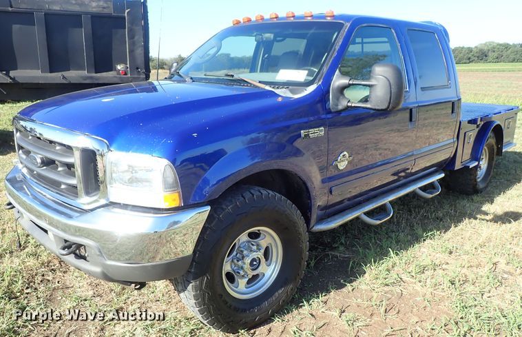 image for item DB7700 2003 Ford F250 Super Duty Crew Cab flatbed pickup truck