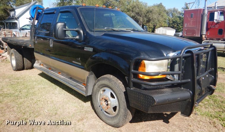 image for item DD4503 1999 Ford F350 Super Duty Crew Cab flatbed pickup truck