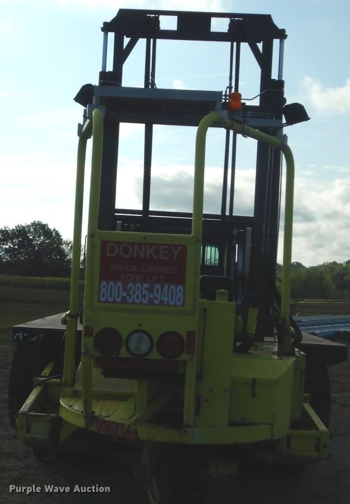image for item DH2091 1999 GMC C6500 dump flatbed truck with Donkey forklift