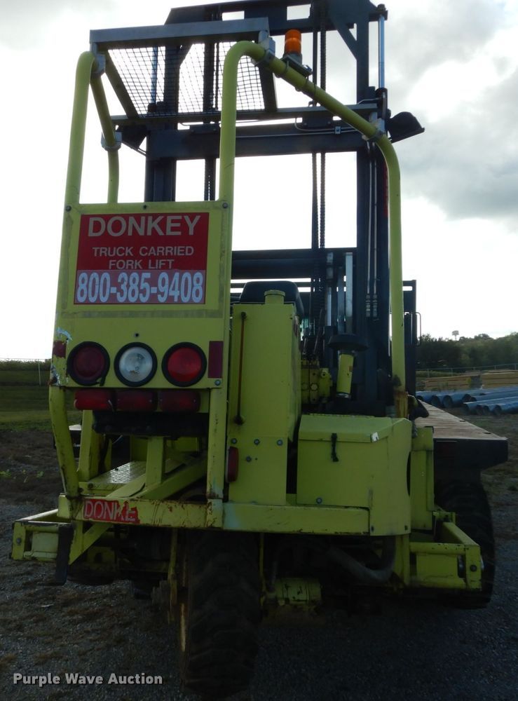 image for item DH2091 1999 GMC C6500 dump flatbed truck with Donkey forklift