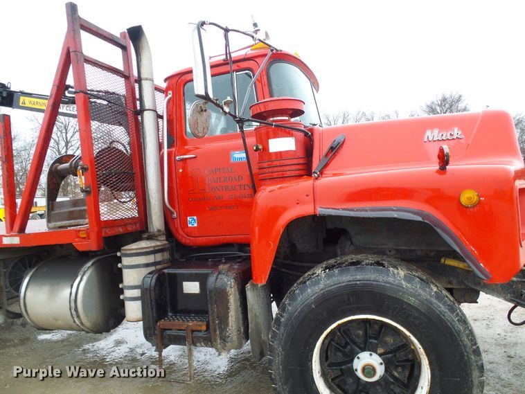 image for item DD1957 1989 Mack DM690S knuckle boom crane truck with grapple