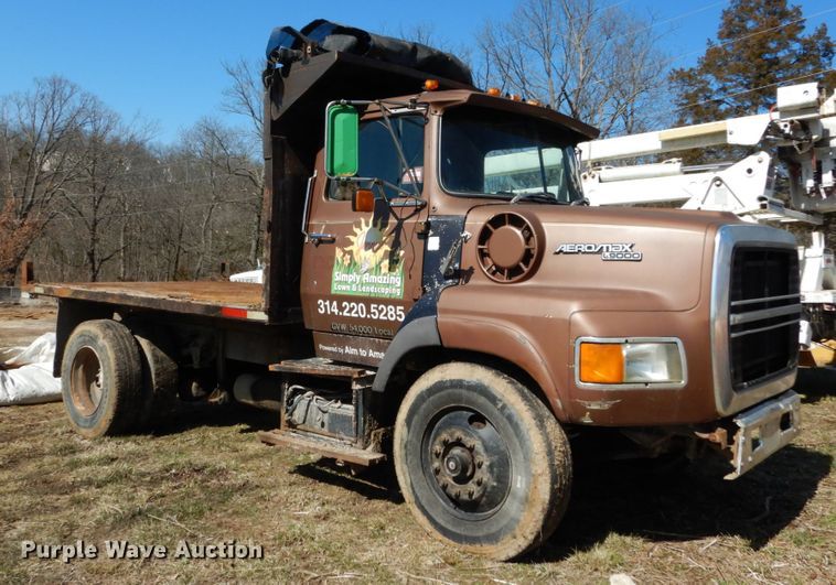image for item GB9795 1990 Ford L9000 flat dump bed truck